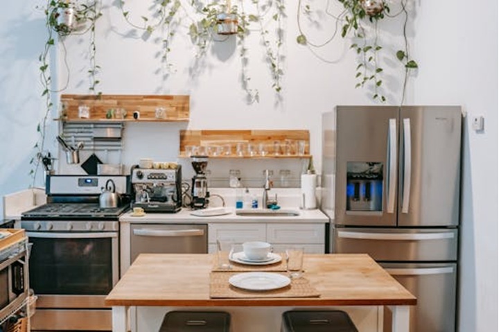 a kitchen with butcher block counters and stainless appliances